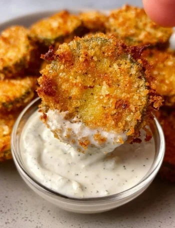 Crispy air fryer fried pickles served with a dipping sauce