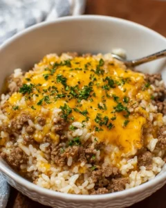 Cheesy Ground Beef and Rice Casserole topped with melted cheese and herbs