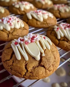 Chewy maple cinnamon cookies with white chocolate chips on a baking sheet.