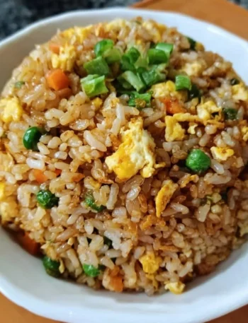 Bowl of easy homemade fried rice with colorful vegetables and eggs.