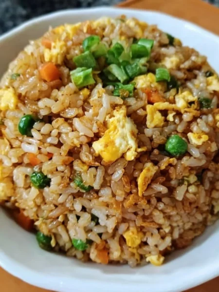 Bowl of easy homemade fried rice with colorful vegetables and eggs.
