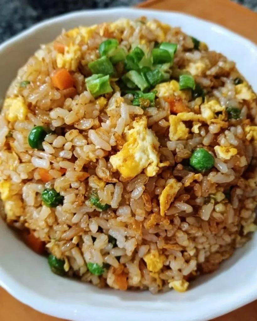 Bowl of easy homemade fried rice with colorful vegetables and eggs.