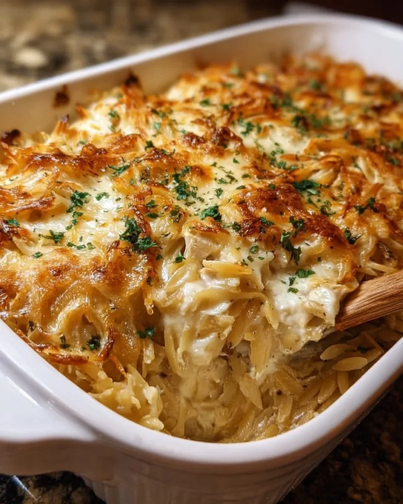 French onion chicken orzo casserole topped with melted cheese