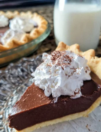 Delicious Old Fashioned Chocolate Pie served on a rustic wooden table