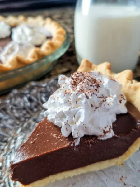 Delicious Old Fashioned Chocolate Pie served on a rustic wooden table