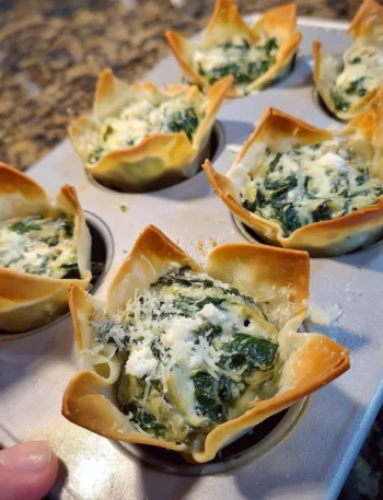 Delicious spinach and artichoke wonton cups served as a party appetizer.