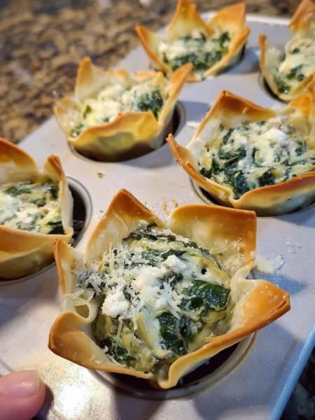 Delicious spinach and artichoke wonton cups served as a party appetizer.