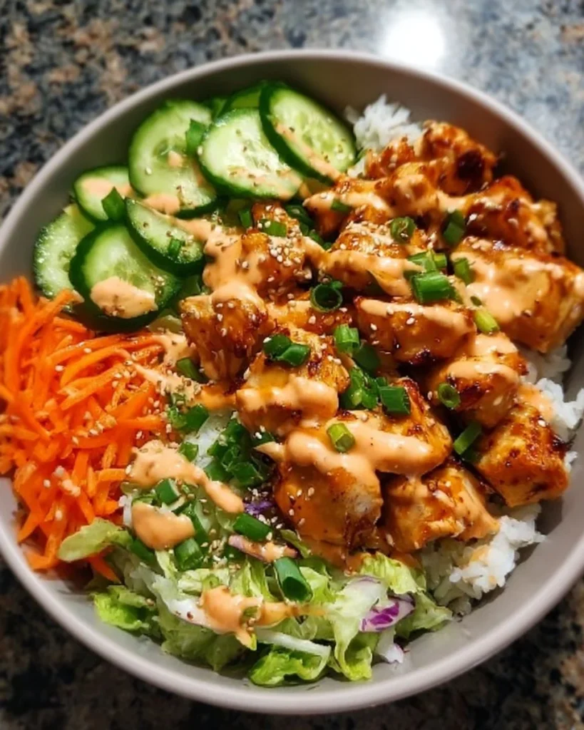 Delicious Bang Bang Chicken Bowl with spicy sauce and fresh ingredients.