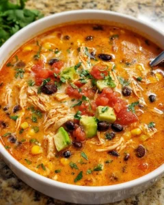 Bowl of flavorful Chicken Enchilada Soup topped with cheese and cilantro