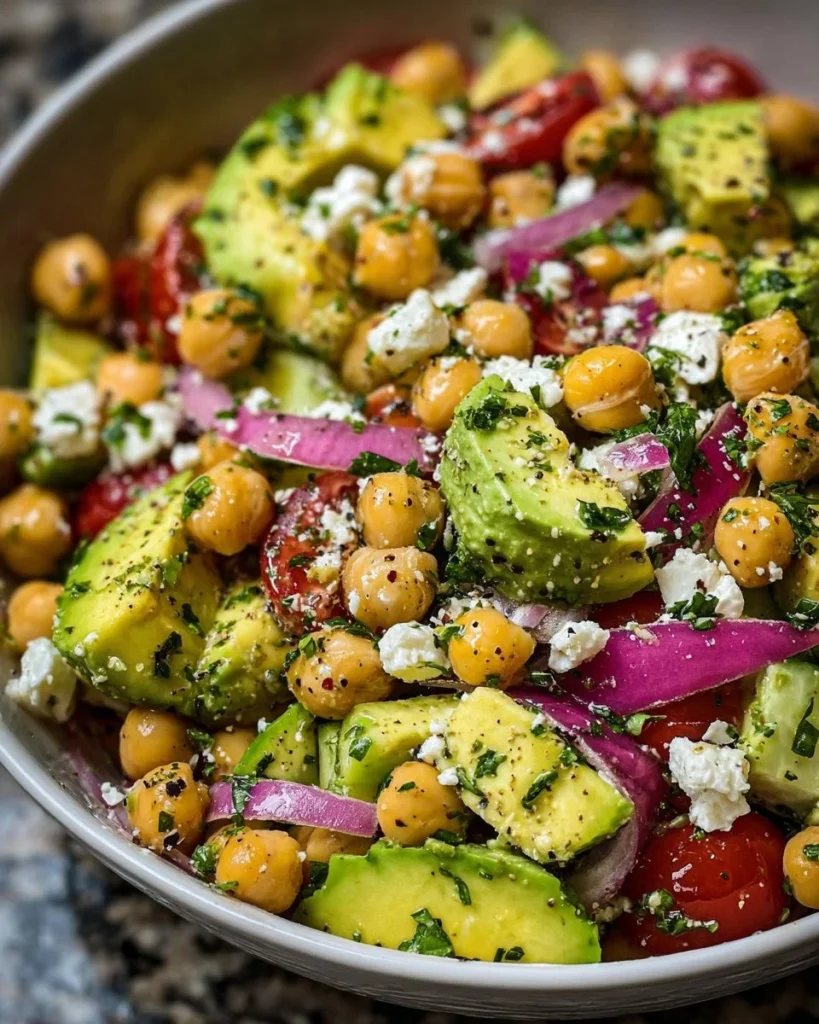 Chickpea Feta Avocado Salad topped with fresh ingredients in a bowl.
