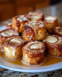 Plate of delicious Cinnamon Roll French Toast Bites topped with icing
