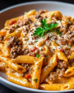Delicious creamy beef pasta dish served with grated cheese and herbs.