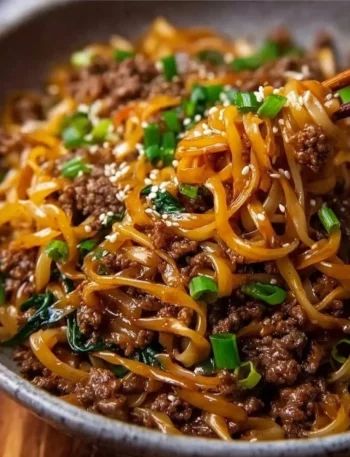 Bowl of easy Mongolian Ground Beef Noodles garnished with green onions