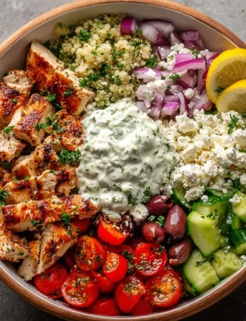 Delicious Greek chicken bowl with fresh vegetables and herbs