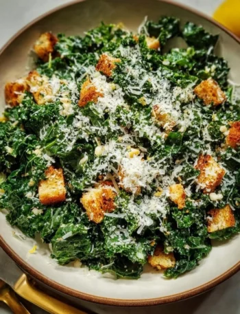 Lemon Parm Kale Salad with fresh ingredients and cheese on a plate