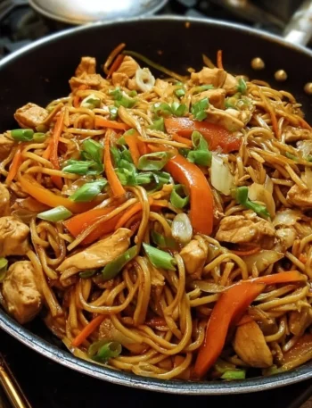 A delicious plate of Chicken Lo Mein with colorful vegetables and noodles.