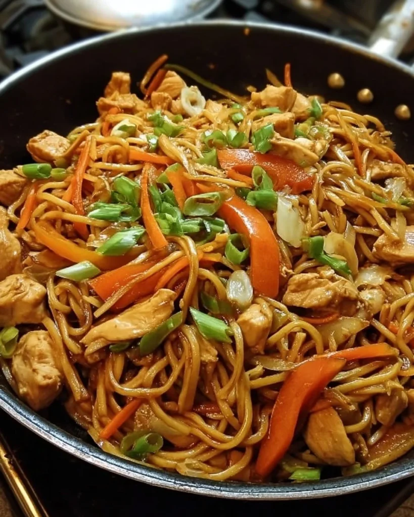 A delicious plate of Chicken Lo Mein with colorful vegetables and noodles.