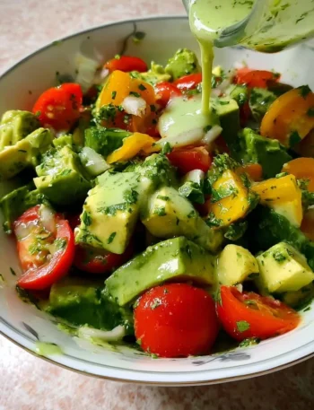 Avocado salad with lime cilantro dressing on a plate.
