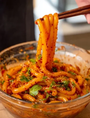 Delicious spicy potato noodles topped with fresh herbs and spices